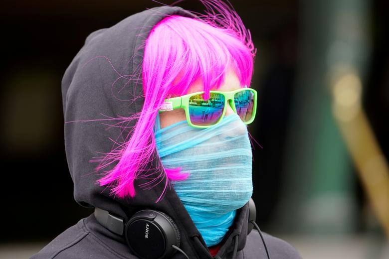 A person wears a scarf as a protective face mask in Melbourne after it became the first city in Australia to enforce mask-wearing in public. REUTERS/Sandra Sanders